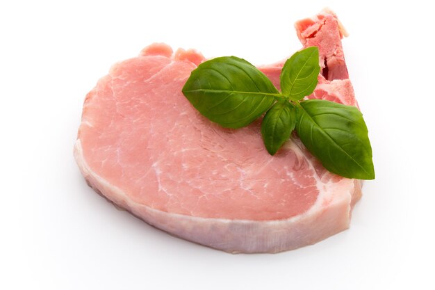 Bistecca di manzo crudo fresco isolato su superficie bianca, vista dall'alto.