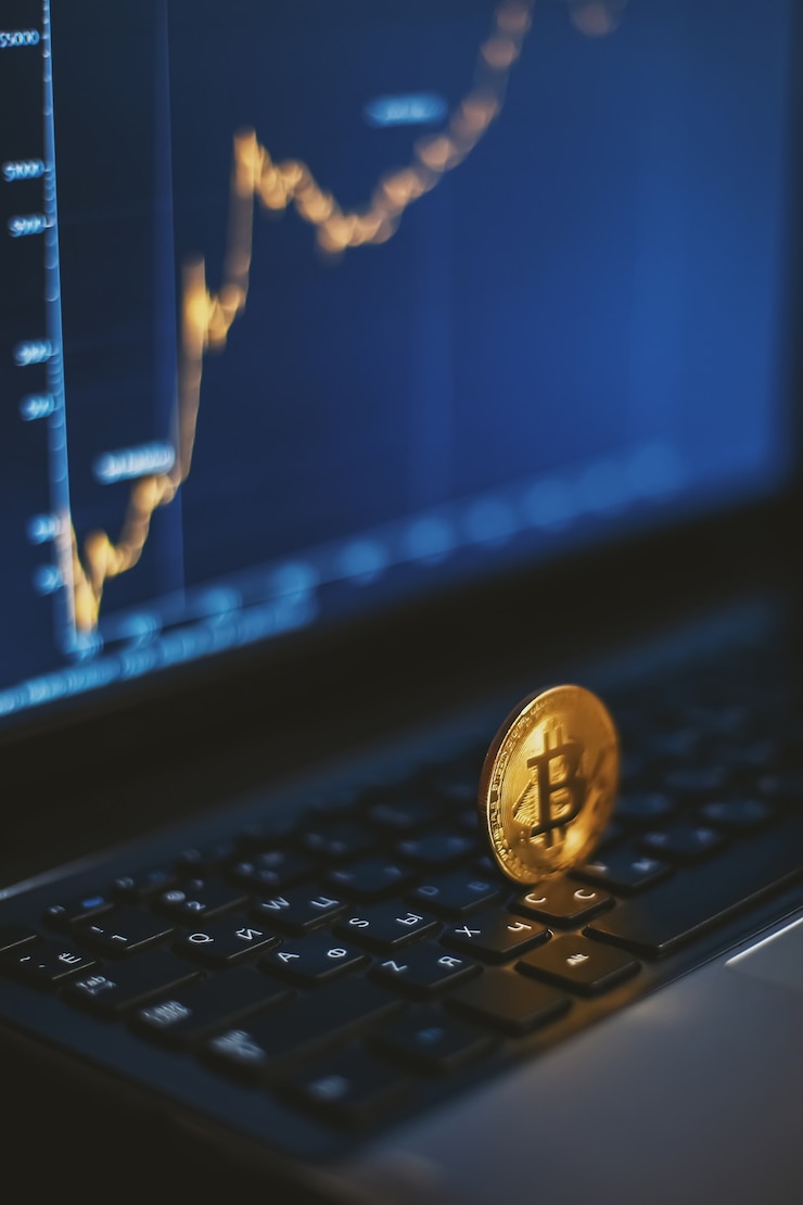 Photo bitcoin on computer keyboard and growth chart