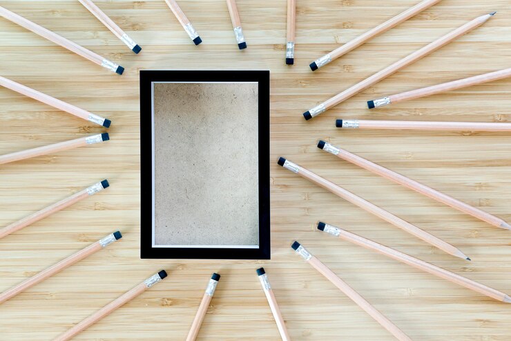 Photo black picture frame with pencil on a wooden table design empty frames