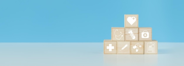 Blocco di legno con icone mediche sanitarie sfondo blu impilamento scatola cubo di legno concetto di trattamento sanitario medico