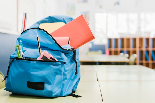 Borsa da scuola con vari strumenti sulla scrivania