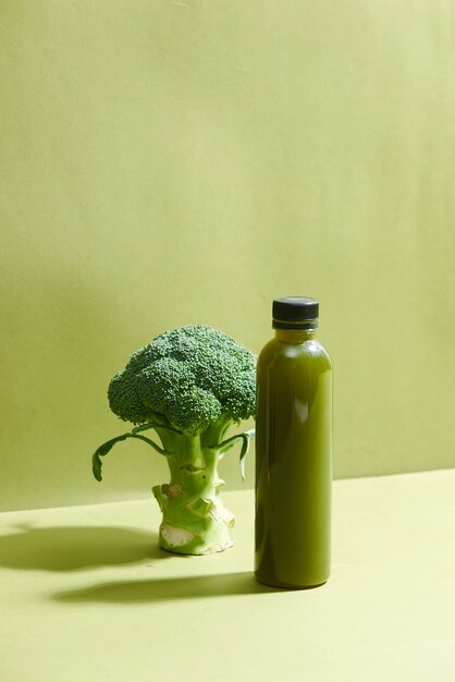 Bottiglia del succo di broccoli fresco sul tavolo. Bevanda salutare.
