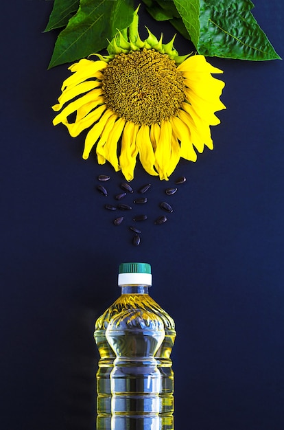 Bottiglia di olio di girasole, fiori e semi per servire