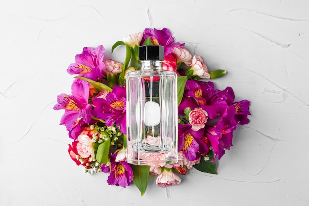 Bottiglia di profumo in un mazzo di fiori freschi