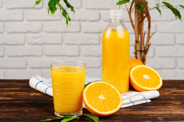 Bottiglia di succo d'arancia fresco sulla tavola di legno