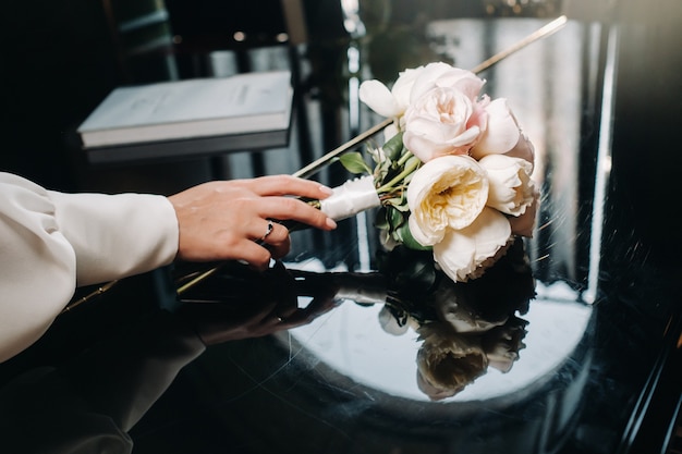 Bouquet da sposa con rose e boutonniere.