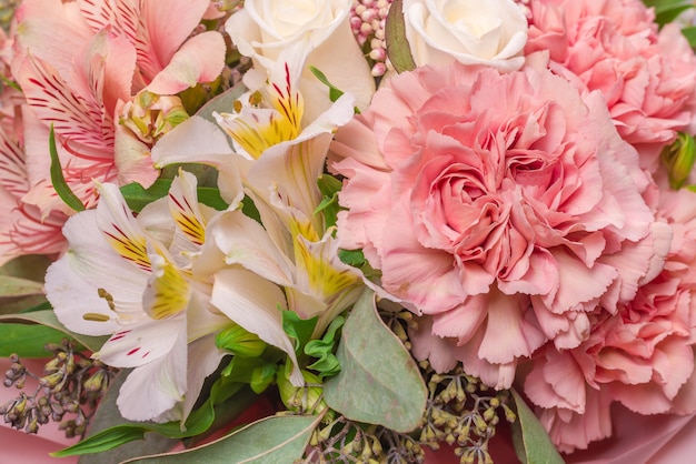 Bouquet di fiori rosa tenui in carta da regalo rosa