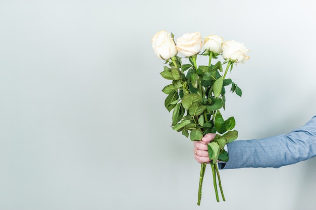 Bouquet di rose bianche nelle mani. San Valentino