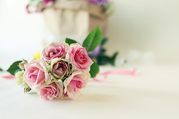 Bouquet di rose fresche un pacchetto con fiori su uno sfondo chiaro concetto di un romantico