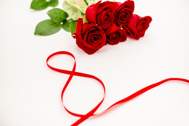 Bouquet di rose rosse con un nastro rosso.