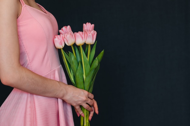 Bouquet di tulipani rosa nelle mani delle donne