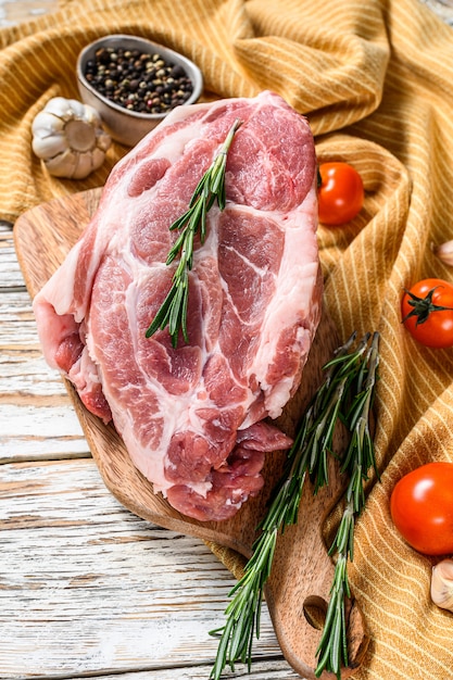 Braciola di maiale cruda con foglie di erbe e spezie