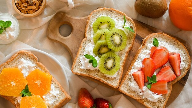 Brindisi sano con frutta fresca e crema di formaggio fatto in casa Toast al kiwi Toast alla fragola Toast all'arancia