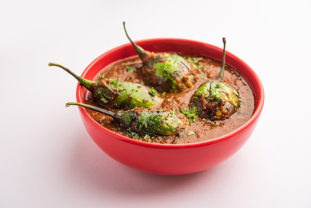 Brinjal curry also known as spicy baingan or eggplant masala, a popular main course recipe from India served in a bowl, karahi or pan