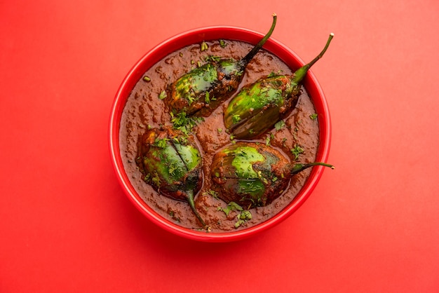 Brinjal curry also known as spicy baingan or eggplant masala, a popular main course recipe from India served in a bowl, karahi or pan
