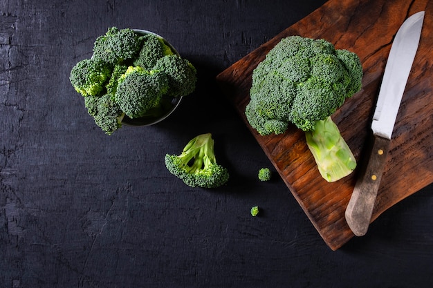 Broccoli crudi freschi su fondo di legno.