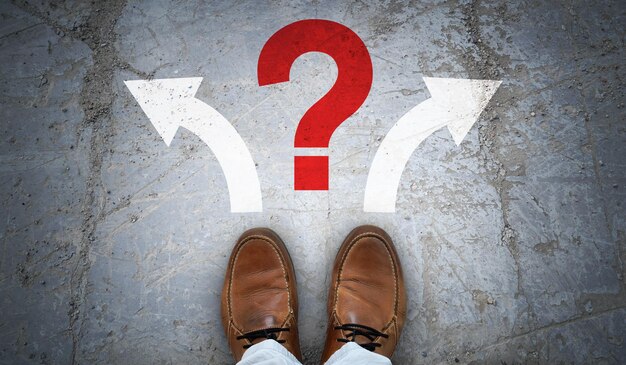 Brown leather shoes two arrows and question mark problem concept
