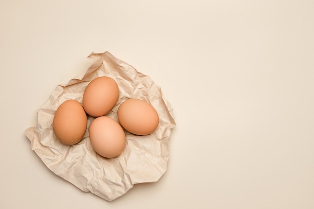 Brown uova di gallina fresche su carta kraft rugosa.