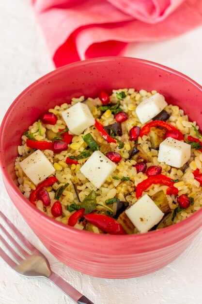 Bulgur con formaggio, pepe, melanzane e melograno.