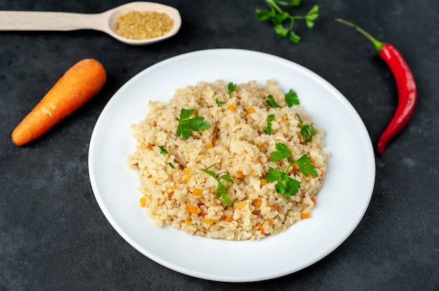 Bulgur con verdure su un piatto bianco