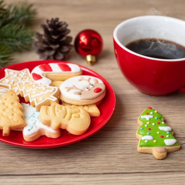 Buon Natale con biscotti fatti in casa e tazza di caffè su sfondo tavolo in legno Festa della vigilia di Natale e concetto di felice anno nuovo