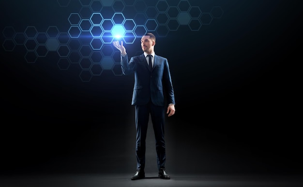 business, persone, realtà aumentata e concetto di tecnologia futura - uomo d'affari che lavora con un ologramma di rete virtuale su sfondo nero