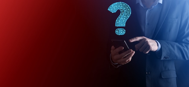 Businessman hand holding,touching question mark low poly icon sign.Banner with copy space. Place for text