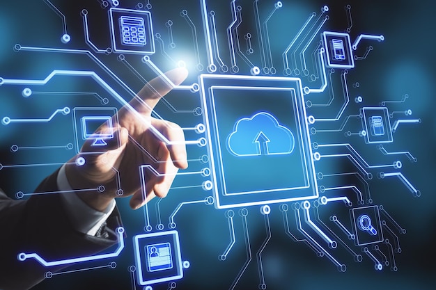Businessman hand pointing at creative glowing circuit cloud computing interface on blurry blue bokeh background Information technology and network concept
