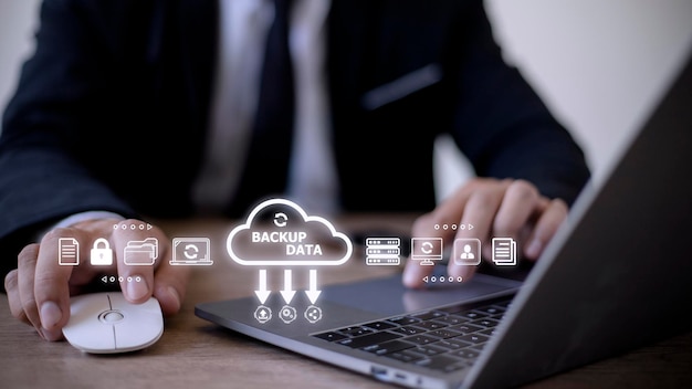 Businessman using a computer to backup storage data Internet technology concept for backup online documentation database and digital file storage system or softwarefile access doc sharing