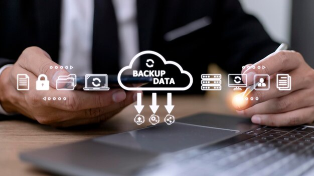 Businessman using a computer to backup storage data Internet technology concept for backup online documentation database and digital file storage system or softwarefile access doc sharing