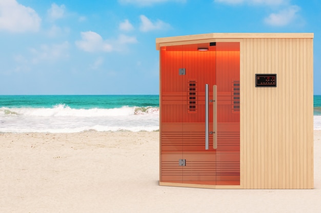 Cabina sauna finlandese a infrarossi classica in legno sull'oceano o sulla spiaggia di sabbia di mare primo piano estremo. Rendering 3D