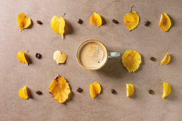 Caffè d'autunno con foglie gialle