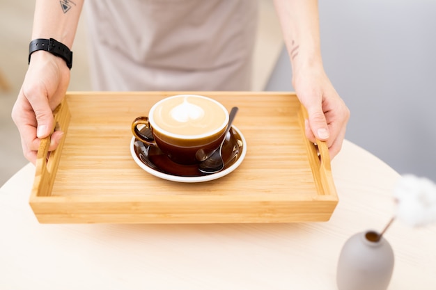 Caffè del mattino sul vassoio di legno