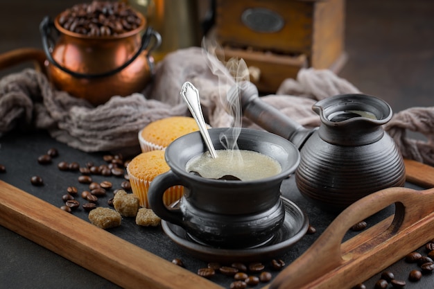 Caffè in una tazza su uno sfondo di chicchi di caffè, su uno sfondo vecchio