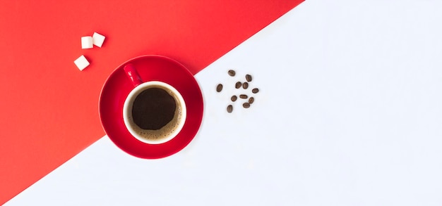 Caffè nero nella tazza rossa sullo sfondo rosso e bianco Copia spazio Vista dall'alto