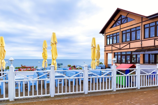 Caffè vuoto sulla spiaggia senza visitatori Argine in una giornata nuvolosa