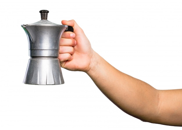 Caffettiera della tenuta della mano sopra fondo bianco isolato