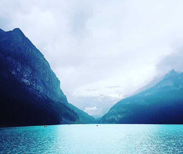 Calm lake against mountain range
