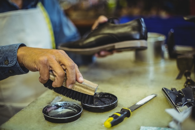 Calzolaio che lucida una scarpa