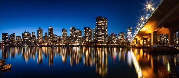 Cambie Bridge a False Creek con edifici moderni della città di notte dopo il tramonto