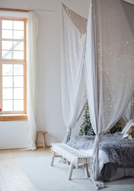 Camera da letto scandinava di Natale con baldacchino bianco