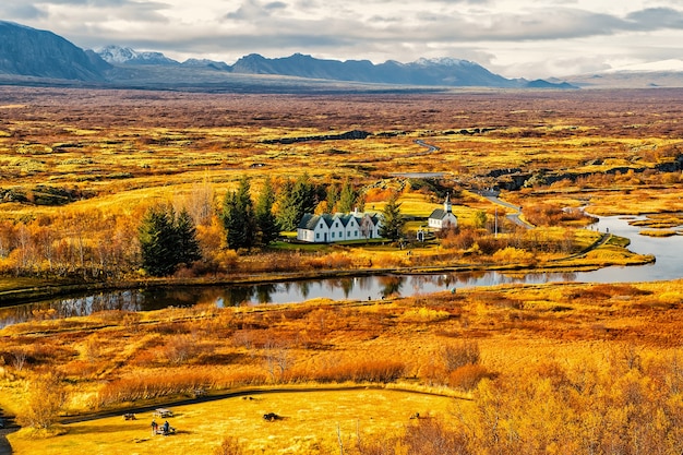 Campagna con fiume, chiesa, case sul paesaggio di montagna in Islanda. Natura, ecologia, autunno. Wanderlust e concetto di viaggio cerchio d'oro