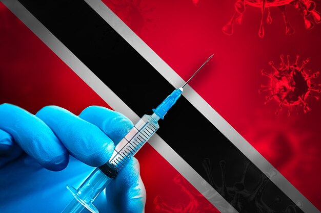 Campagna di vaccinazione di Trinidad e Tobago Covid19 La mano in un guanto di gomma blu tiene la siringa