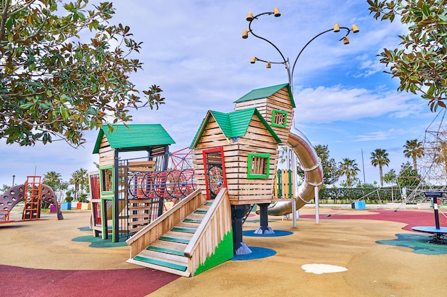 Campo da giuoco di legno variopinto in un parco dei bambini per il gioco del tempo del bambino