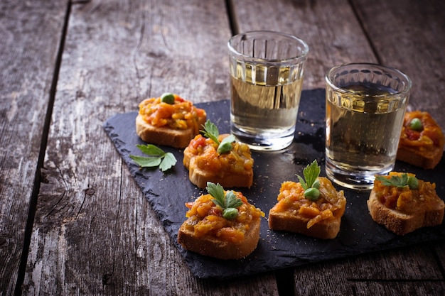 Canape con caviale di melanzane e bicchieri di vino. Messa a fuoco selettiva