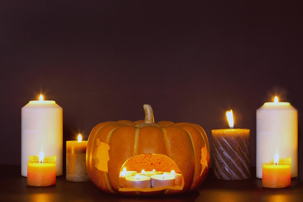 Candele accese per l'illuminazione di Halloween composizione autunnale accogliente atmosfera domestica Zucca in soggiorno