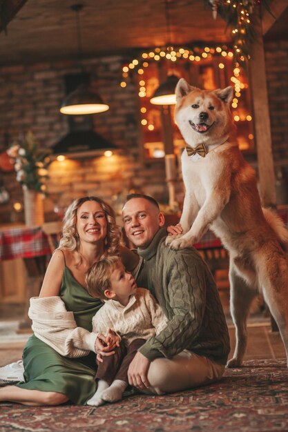 Candida autentica famiglia felice durante l'inverno che si gode insieme le vacanze con il cane a Natale