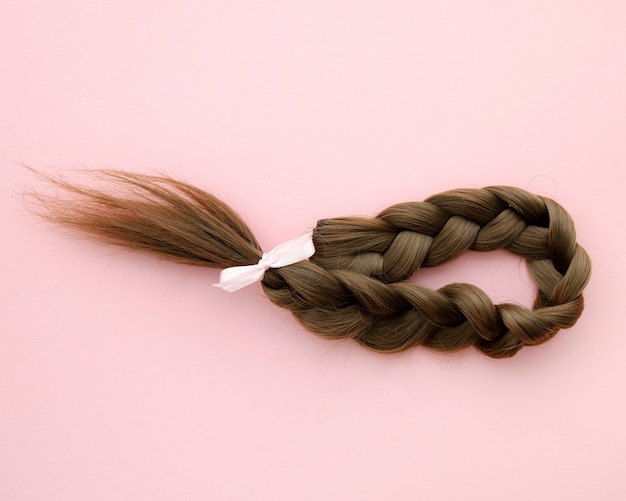 Capelli intrecciati con un fiocchetto rosa