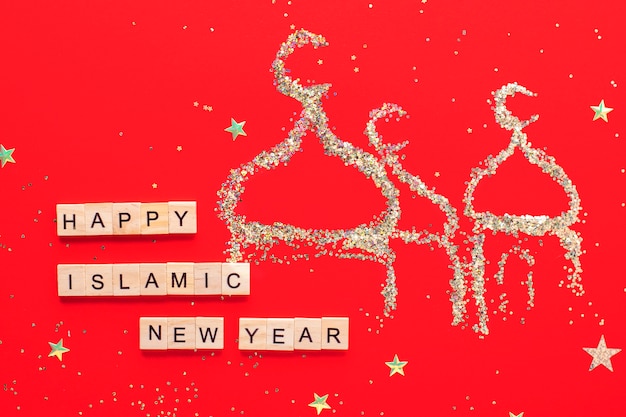 Capodanno islamico. La scritta Happy Islamic New Year su fondo rosso, una moschea dalle scintille.