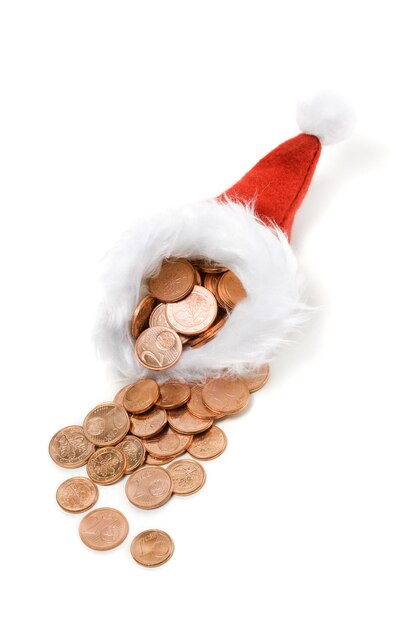 Cappello da Babbo Natale e monetine su bianco